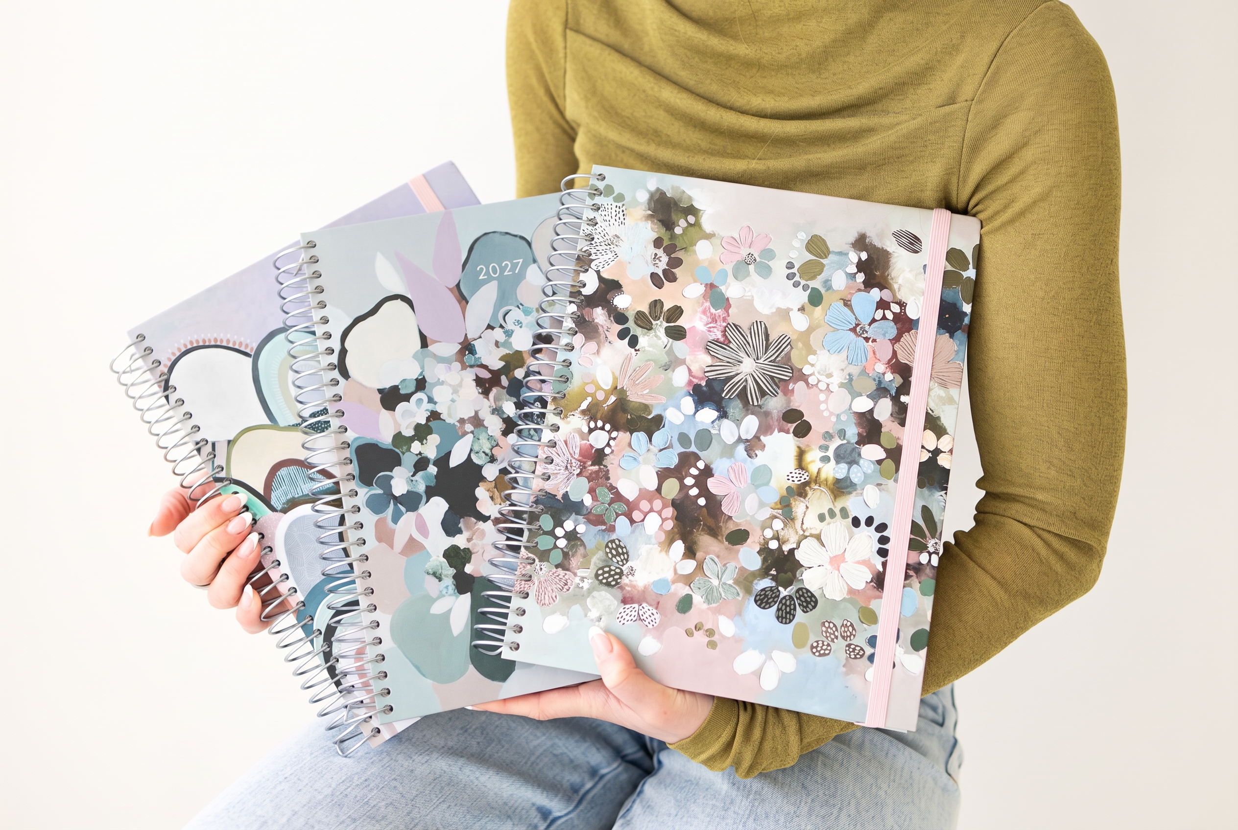 The Arches, Still Life and Wildflower Artist Series planners held in hand